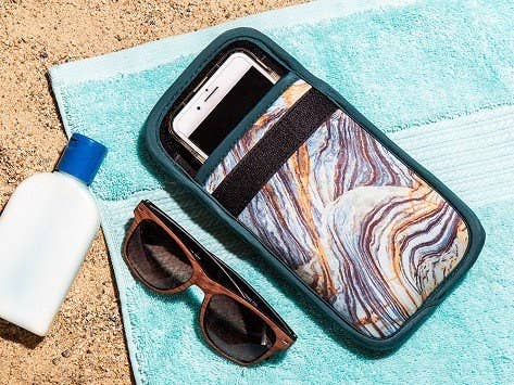 the marble phone case with a phone inside and velcro across the front to close it