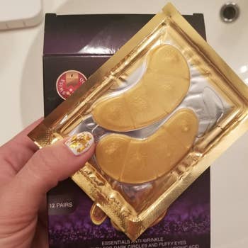 reviewer holding the gold eye pads 