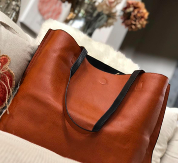 A customer review photo showing the tan side of the bag