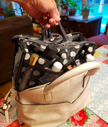 A customer review photo showing them pulling out the insert from their handbag