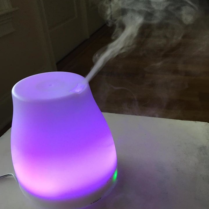 the diffuser glowing a purple color and releasing mist