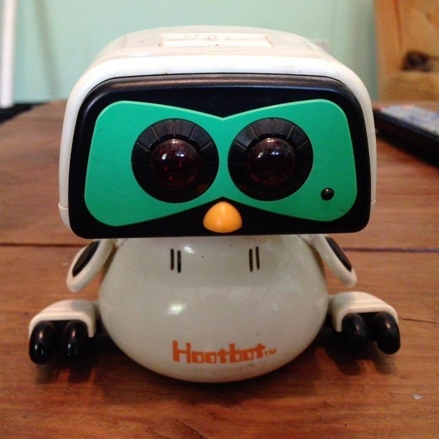 A Hootbot robot owl on a desk.