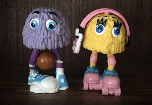 A purple and a yellow McFry Kids Happy Meal Toy.