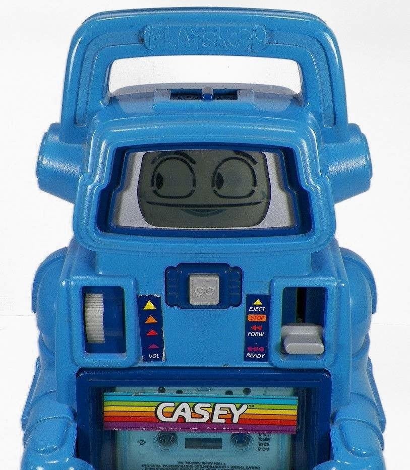 A close up of with a Casey the Talking Robot, which is blue with very simple animated face looking to the side.