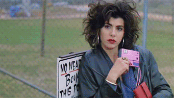 marisa tomei in &quot;my cousin vinny&quot; casually taking a flash photo on a pink camera