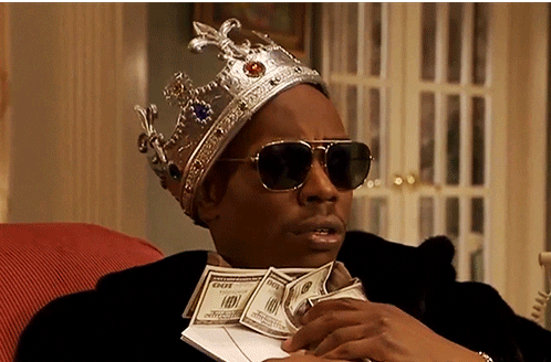 man with crown holding dollar bills