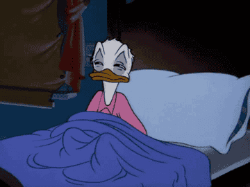 Disney&#x27;s Donald Duck pulling the covers over his head and falling into a pillow