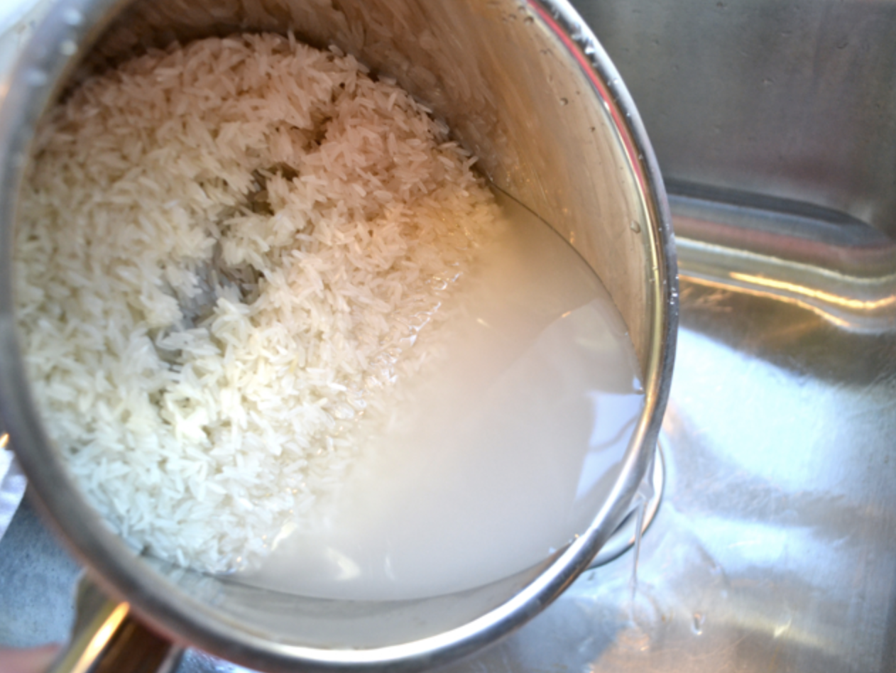 White rinse being rinsed with water in the sink