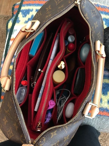 the same reviewer now showing how nice and organized their purse it with the red organizer inside