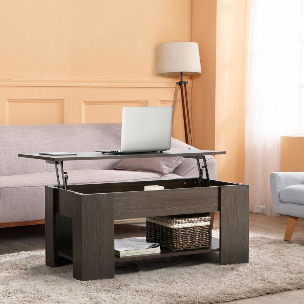 The brown coffee table with a shelf at the bottom and thick inner area with the top lifted up, with a laptop on top, showing how you can use it as a workstation