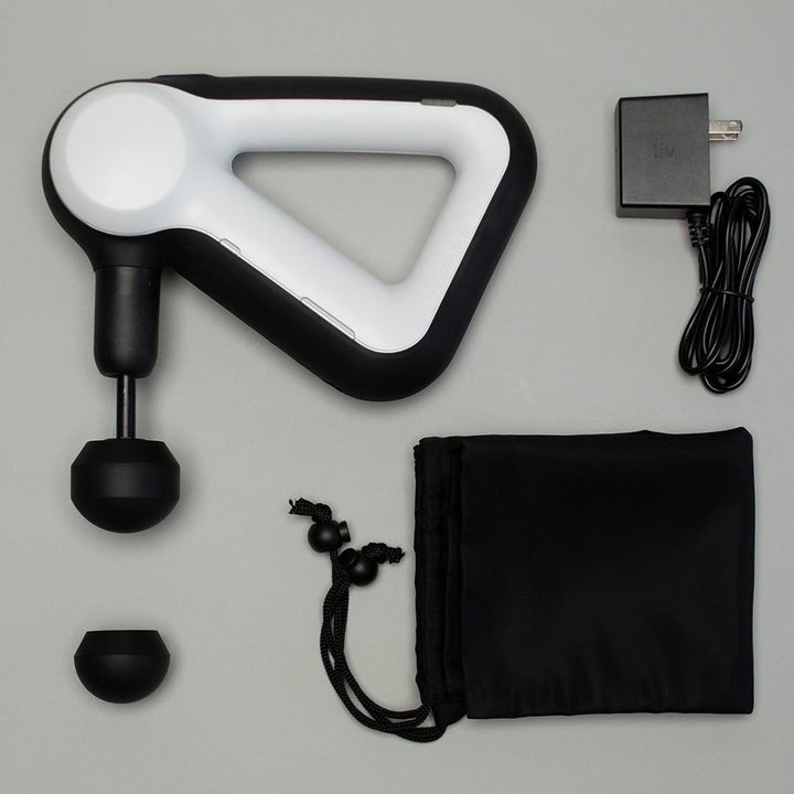 the theragun with the power cord, bag, and two attachments that come with it 