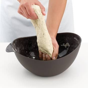 Person pulling dough with maker opened like a bowl