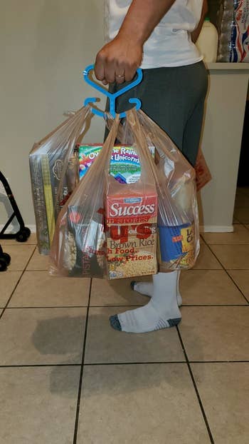 Reviewer photo using the handle to hold three grocery bags full of stuff
