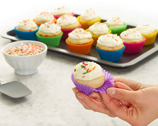 Person peeling back cupcake cover showing flexibility and reusability 