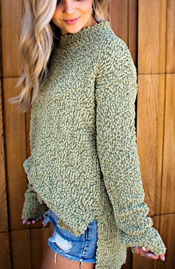 A model wearing the fuzzy green sweater