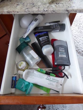 before photo of a reviewer's toiletries messily stored in a drawer