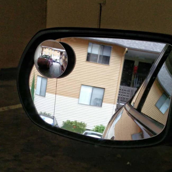Car side mirror with circular addition helping view the back of car