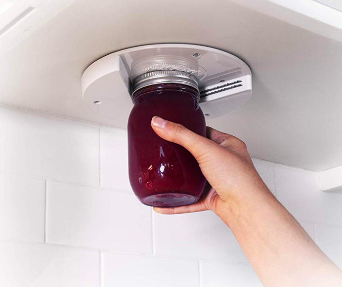 Person opening can with cap screw under cupboards 