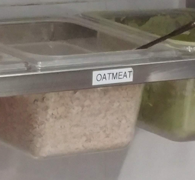 Oatmeal container labeled &quot;oatmeat&quot;