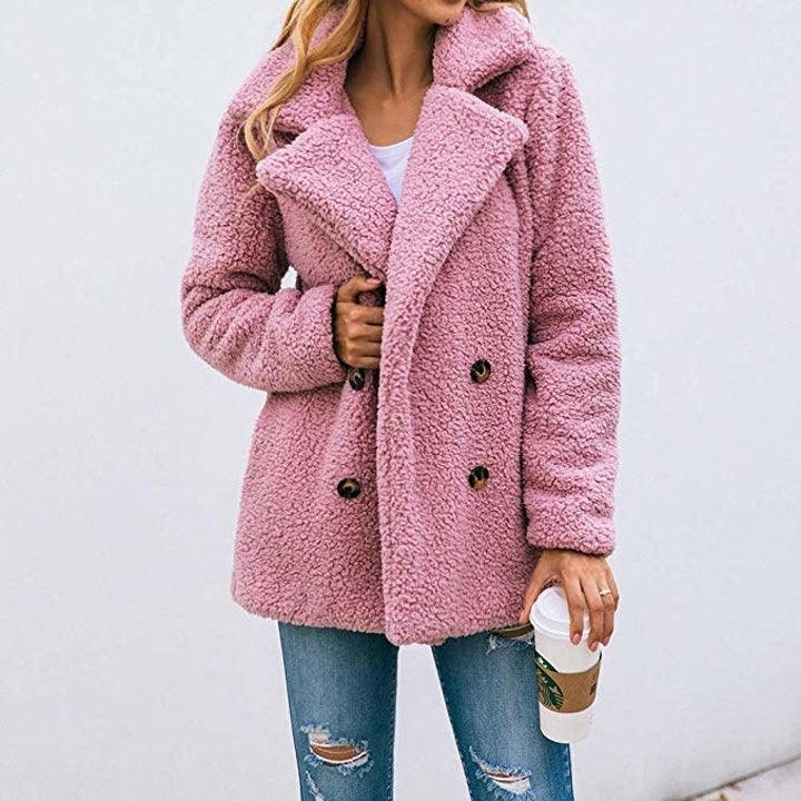 model wearing pink teddy faux fur pea coat with black buttons
