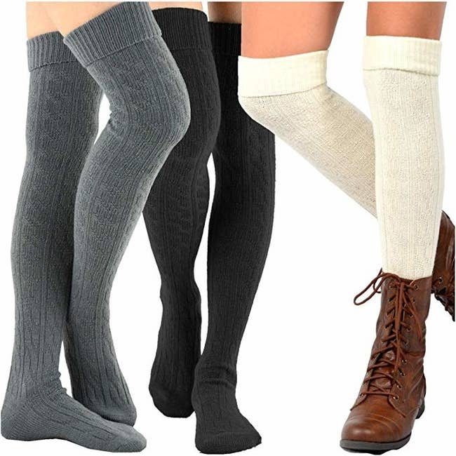 three models wearing thigh high cable knit style socks