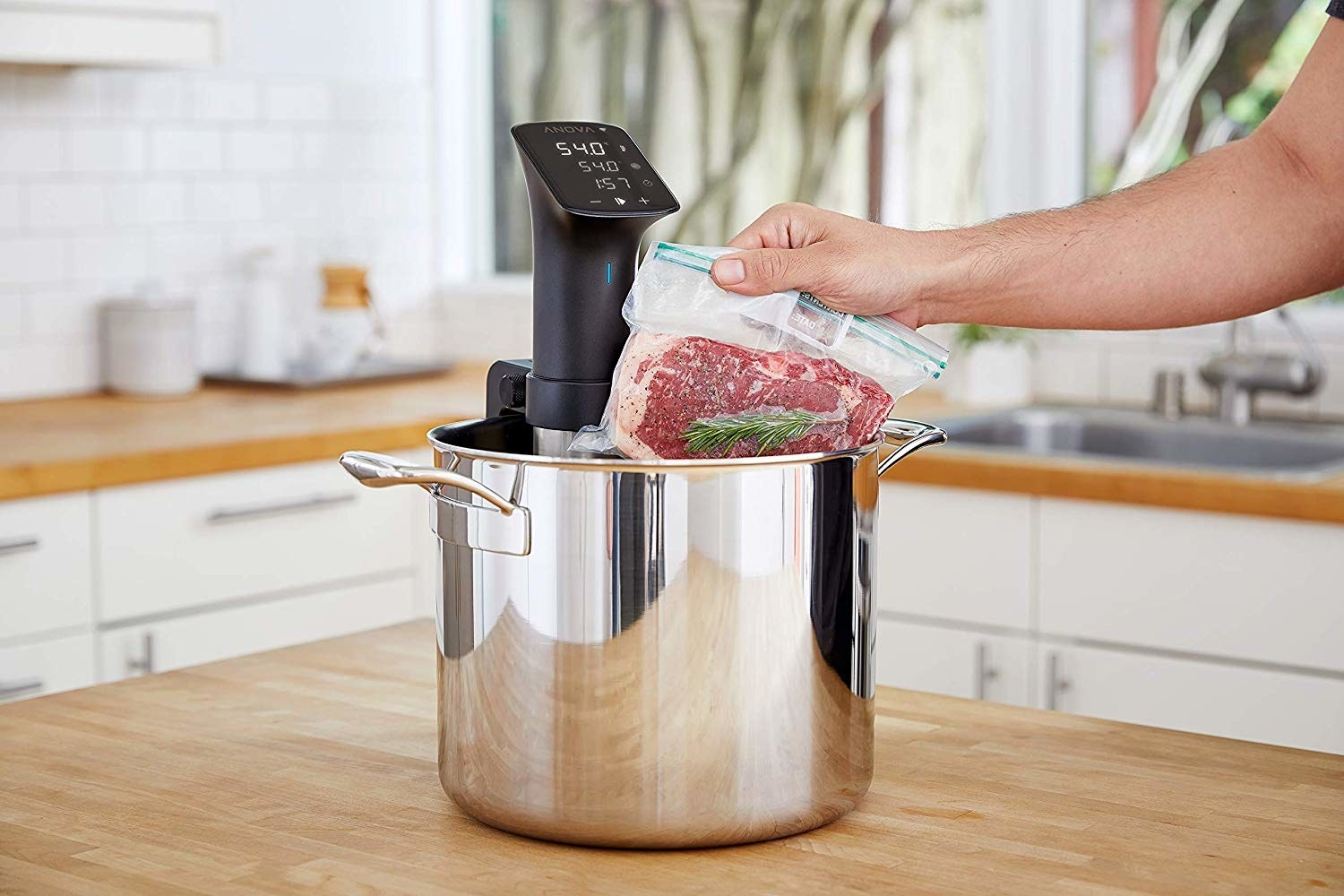 Hand inserted bagged meat into sous vide 