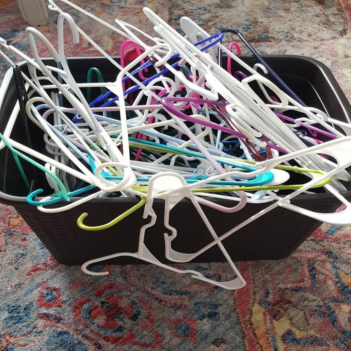 chaotic bundle of plastic hangers in bin 