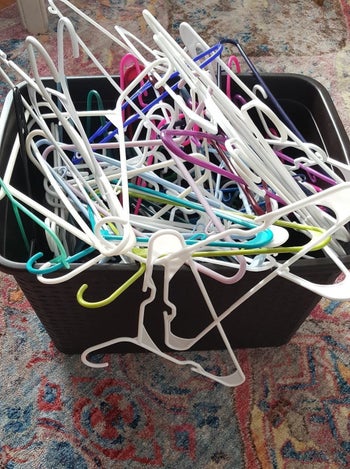 chaotic bundle of plastic hangers in bin 