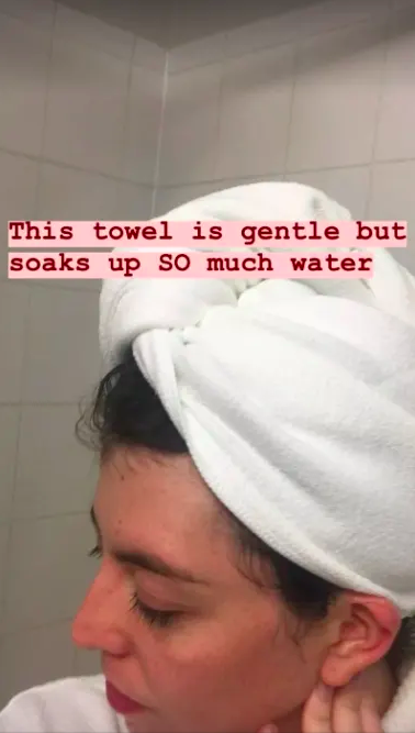 person wearing the towel with the text overlay of &quot;This towel is gentle but soaks up so much water&quot; 