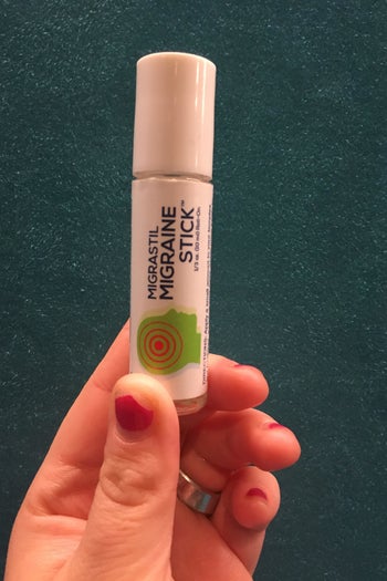 me holding up the lipstick sized tube