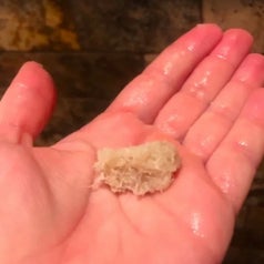 a reviewer holding a clump of dead skin in their hand
