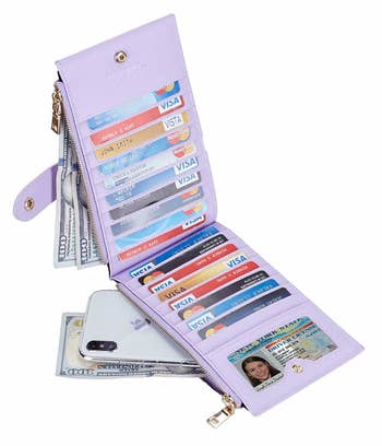 The lilac wallet unfold, holding tons of cards on both sides, with clear ID pocket. A phone and bills are shown coming out of the zippered side