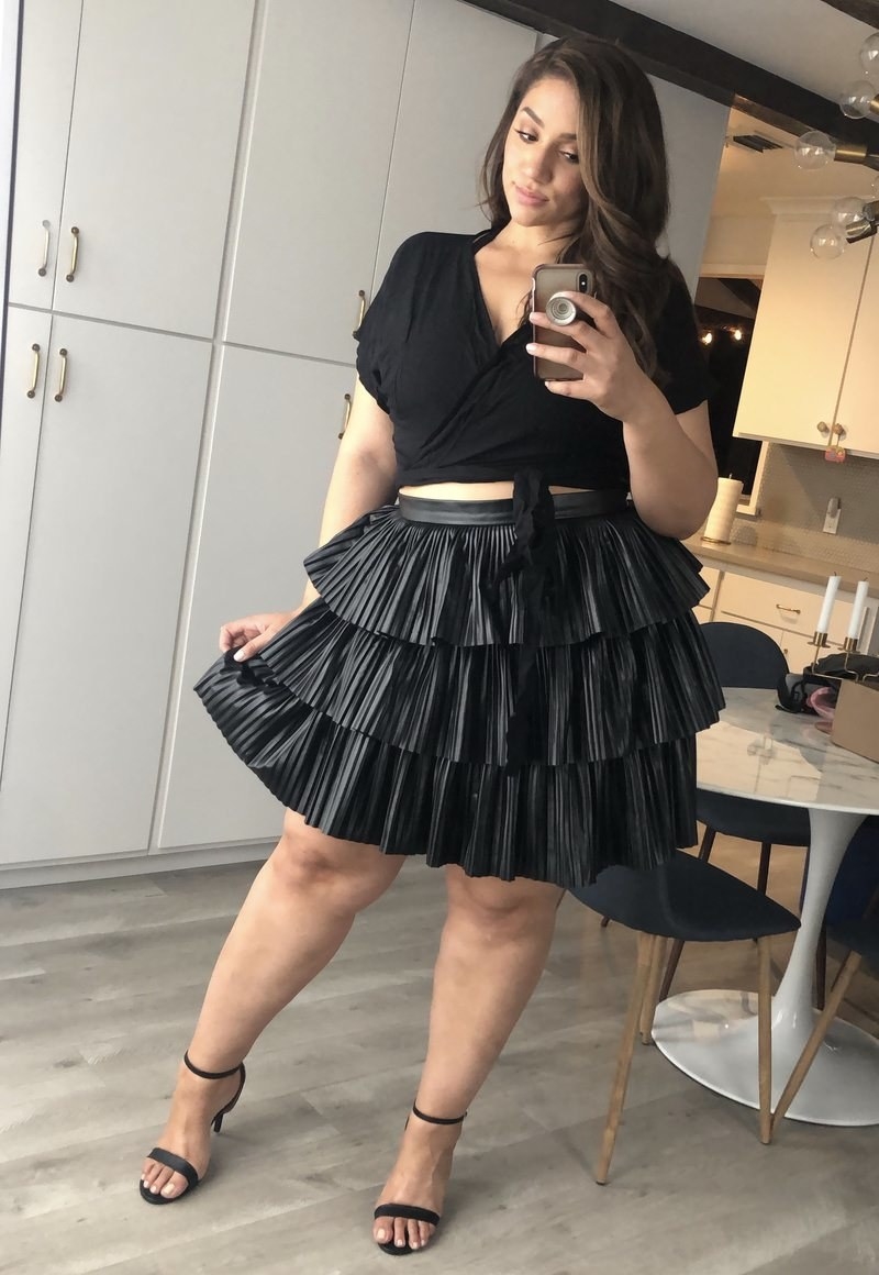 Reviewer in the three-tiered black skirt