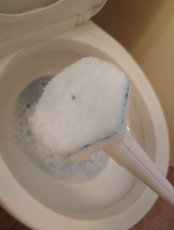 A reviewer image of the soapy sponge end of the wand and a toilet filled with suds