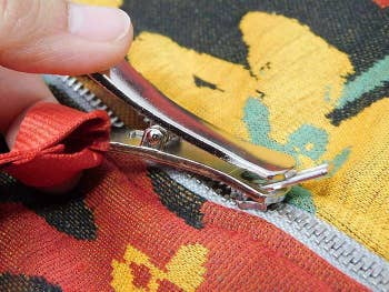 Closeup of how the zipper puller attaches to a zipper