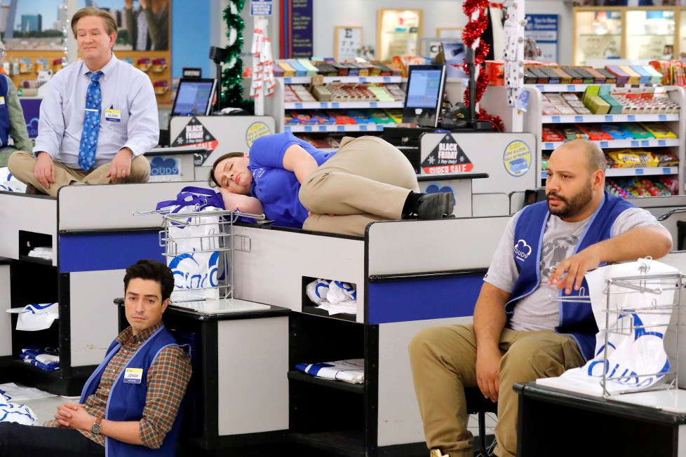 four of the characters at their retail job looking bored and not working