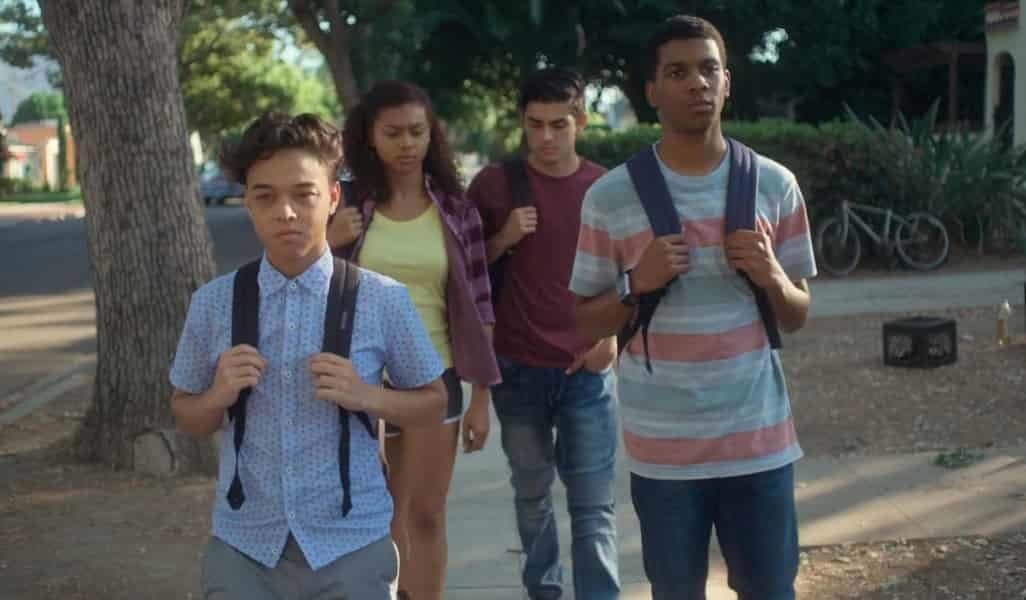 four characters walking down the street with their backpacks