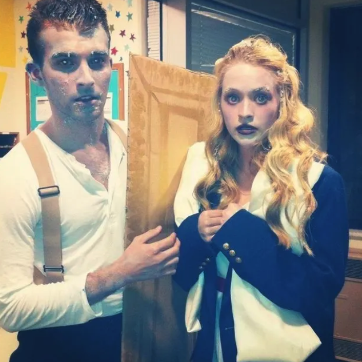 Two people dressed as Jack and Rose with fake ice around their faces