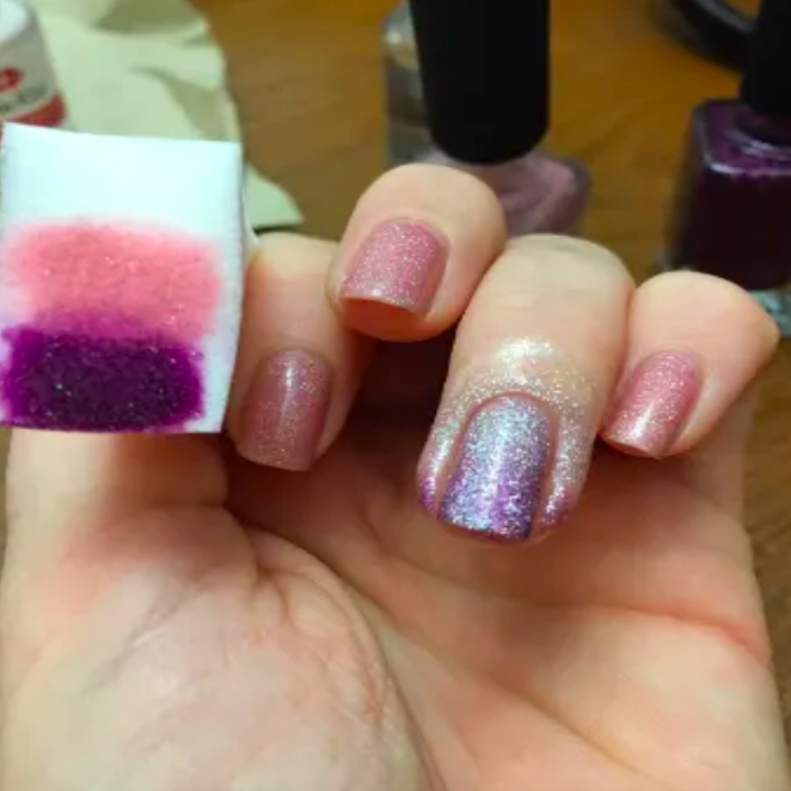 Reviewer with sparkles around nail bed while polishing nails