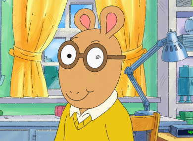 Screenshot of the cartoon character Arthur Read winking.