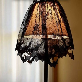 lamp with bat and spiderweb lace on top 