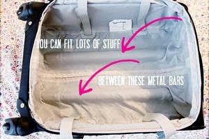 A photo of the space between the metal bars in a rolling suitcase