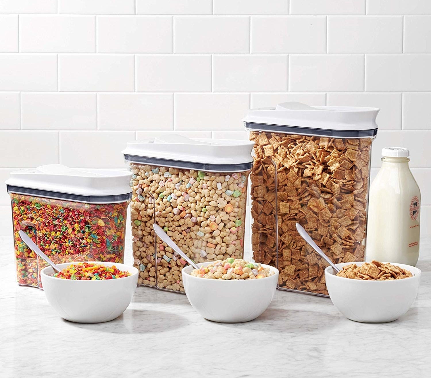 Three containers filled with different types of cereal