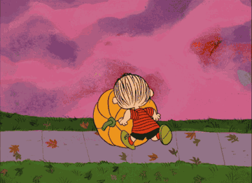 GIF from Charlie Brown of linus rolling a pumpkin down the sidewalk 