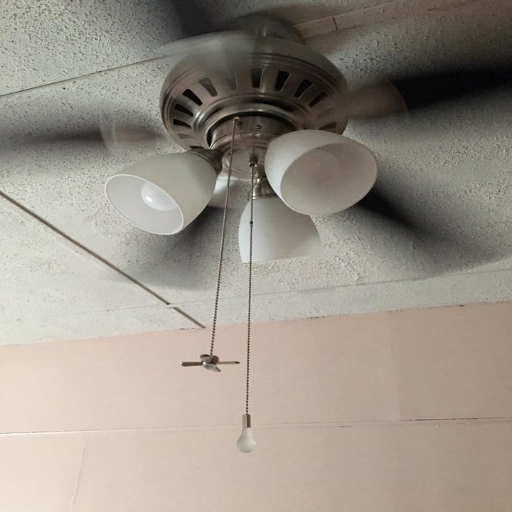 Reviewer image of the chains attached to a ceiling fan and light