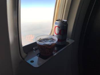A reviewer's diet coke on the shelf attached to an open window
