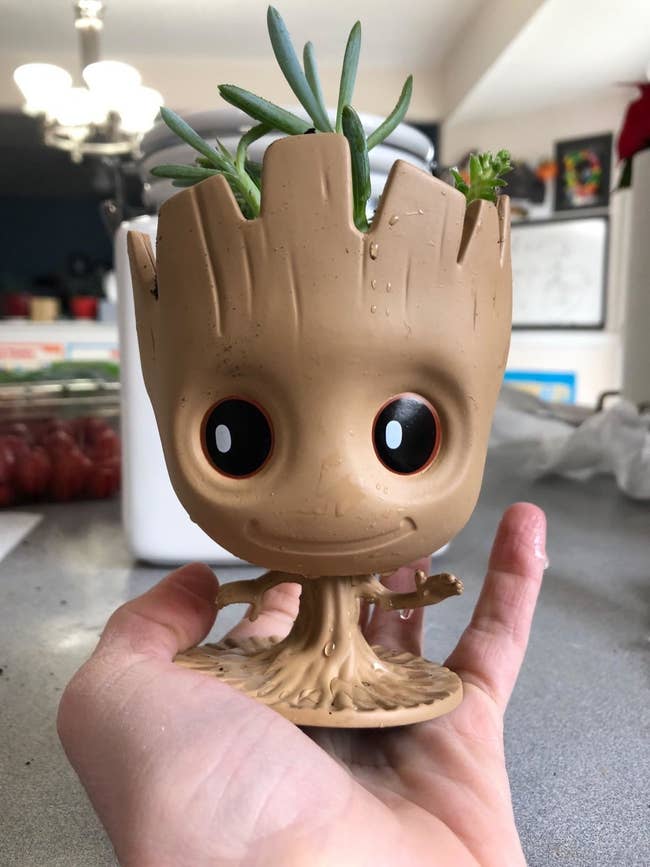baby groot with plant in head