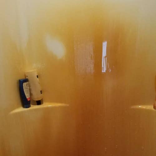 reviewer's pic of rust covered shower surround      