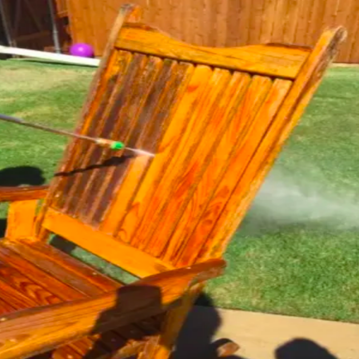 Reviewer refreshing dirty patio chair with water 