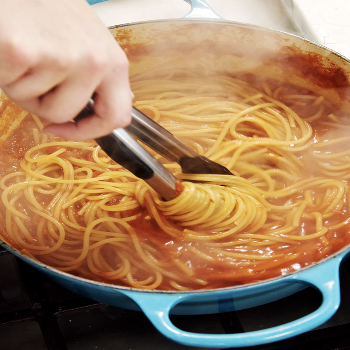 A pot of spaghetti on the stove